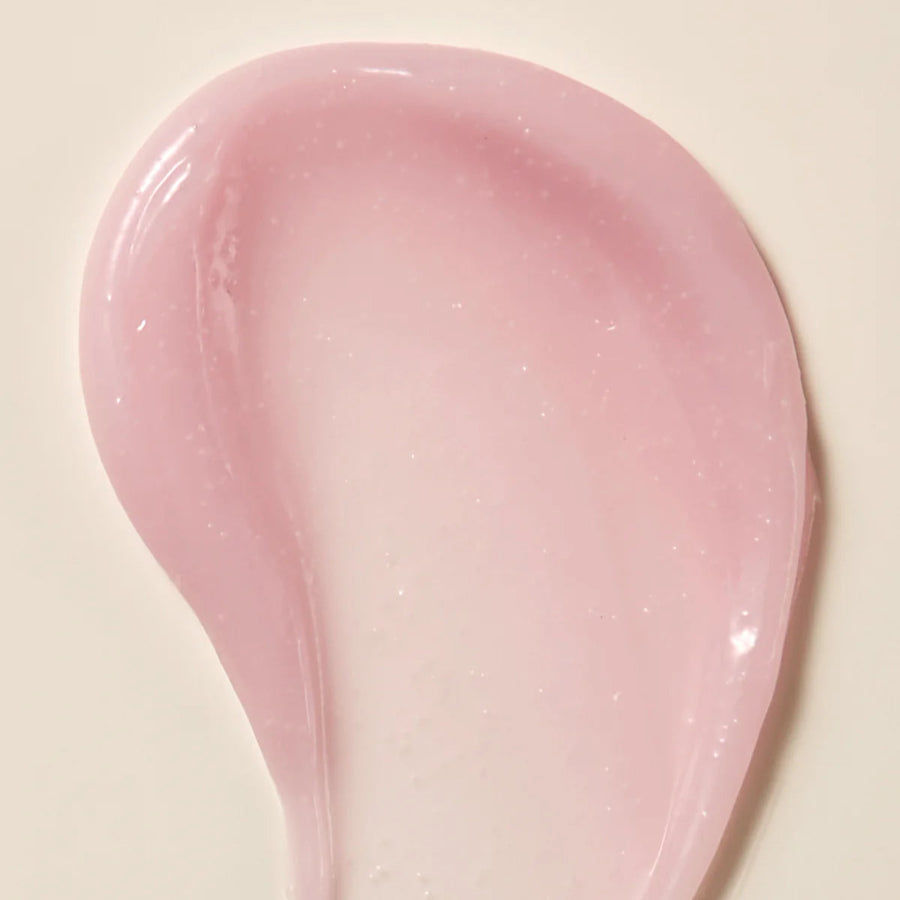 Axis-Y Calamine Pore Control apsule Serum texture reference. The serum is of a light pink gel consistency with tiny capsules in it.
