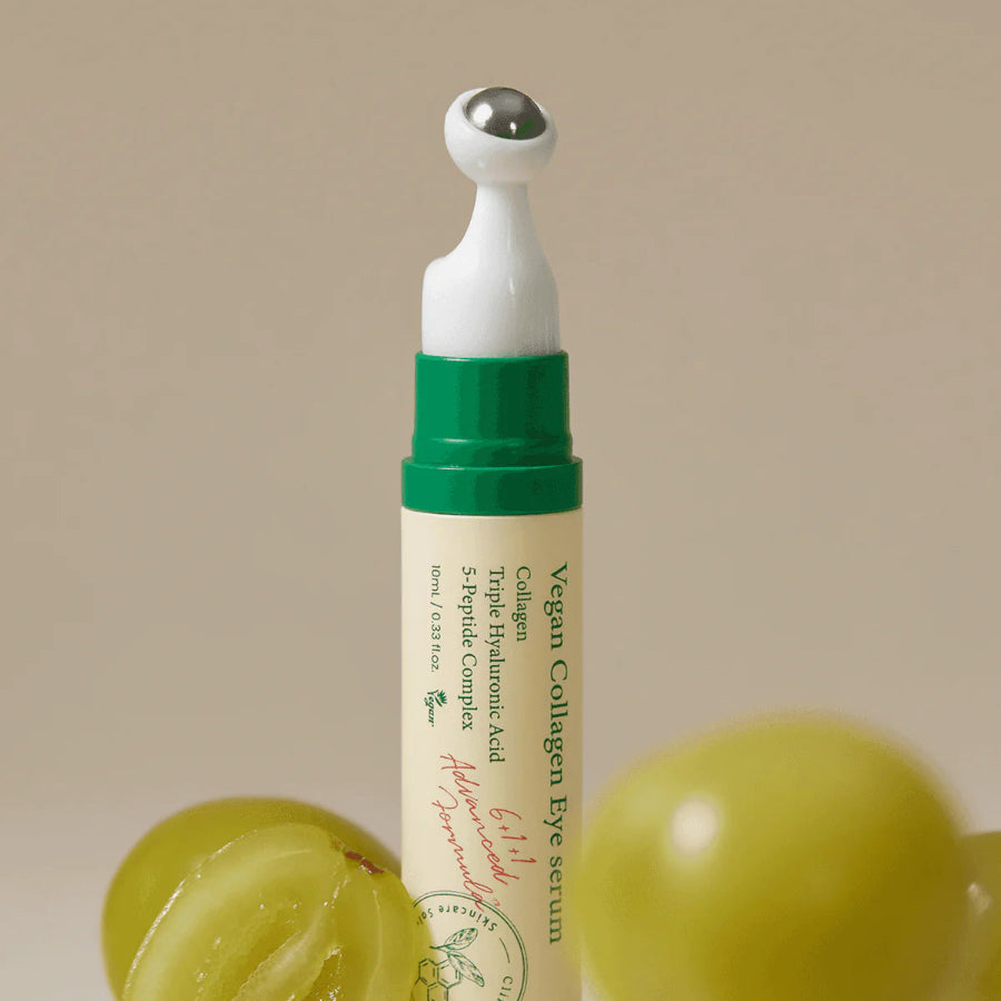 Axis-Y Vegan Collagen Eye Serum tube next to green grapes.